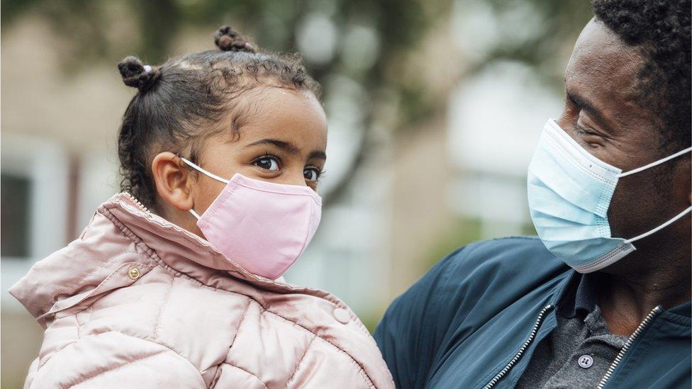 young-girl-and-her-father-wearing-masks