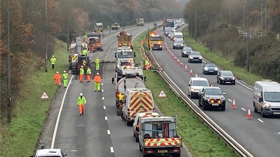 emergency services attending to the scene of the crash on the A1474