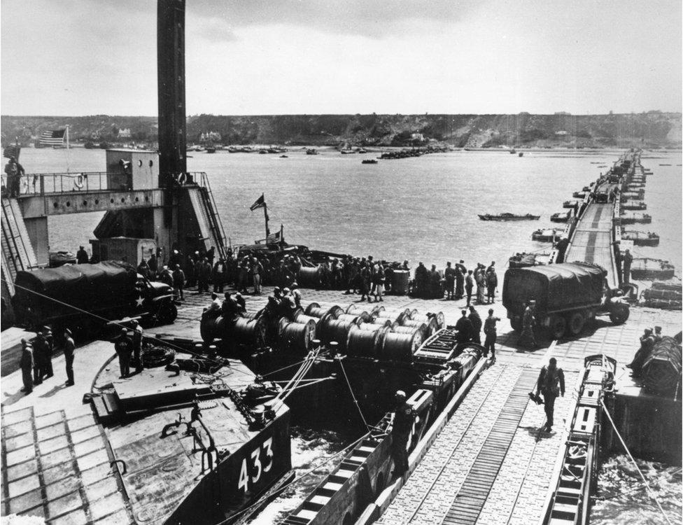 Construction of a Mulberry Harbour, and the unloading of supplies for the Allies at Colleville, France.