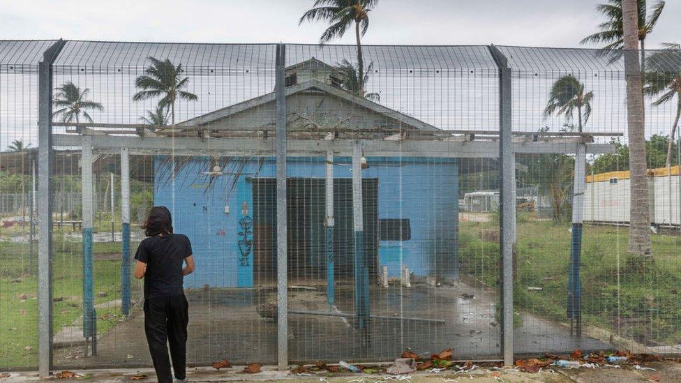 Asylum seeker Behrouz Boochani, stands outside the abandoned naval base on Manus island, where he and other asylum seekers were locked up for the first three years.