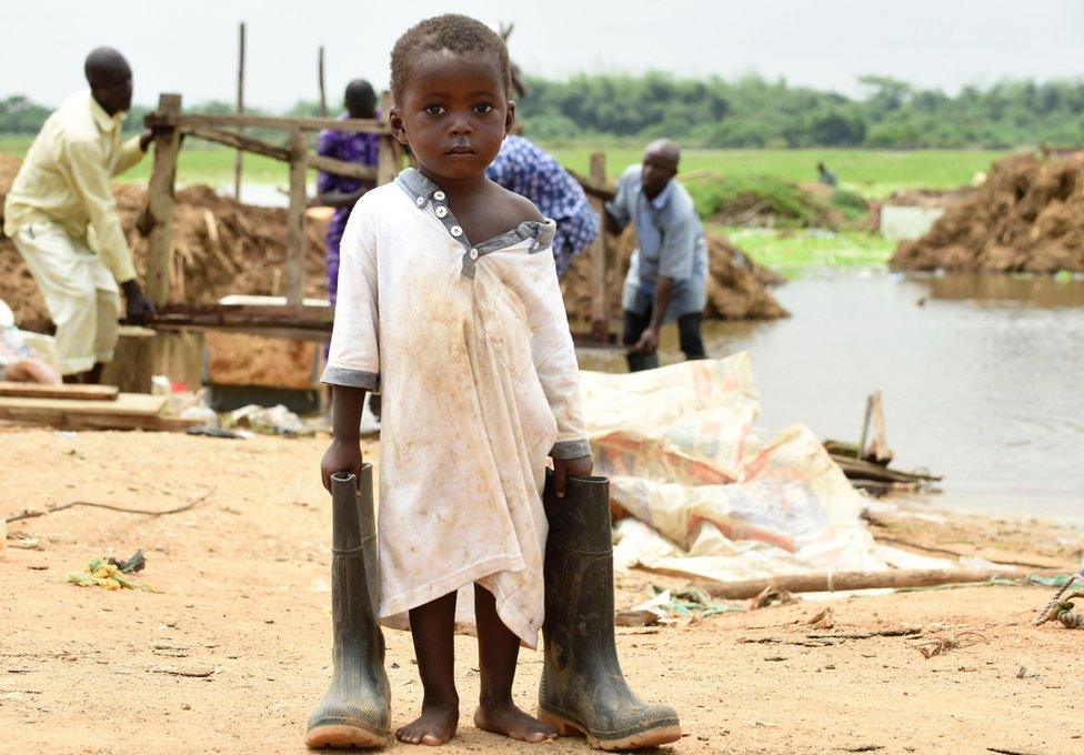 A Nigerian boy carries his father's boots in Ogun State, south-west Nigeria - Wednesday 5 October 2016
