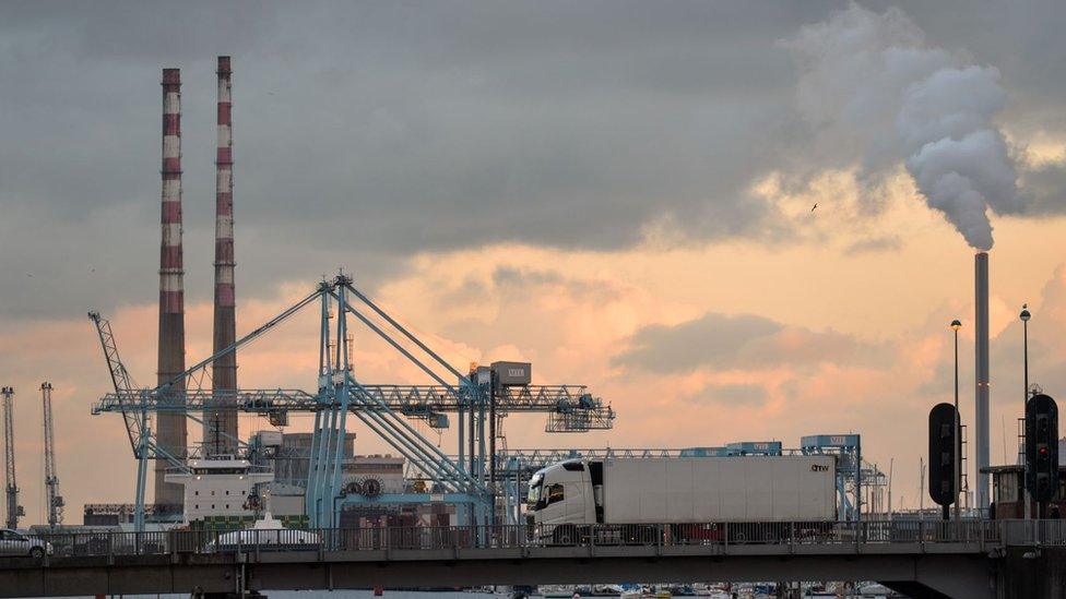 A lorry on Tom Clarke Bridge with a view of Dublin port in the background