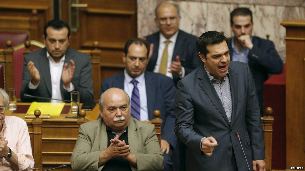 Greek Prime Minister Alexis Tsipras (front, R) is applauded in parliament on 11 July