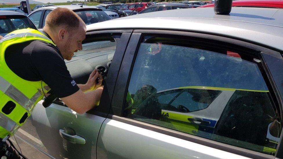 Police officer outside car