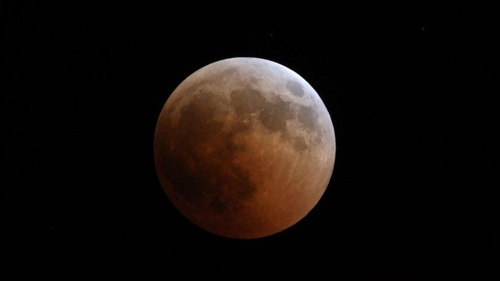 This picture shows the full moon during a "blood moon" eclipse as seen from Oloika town in Magadi, Kenya, on July 27, 2018