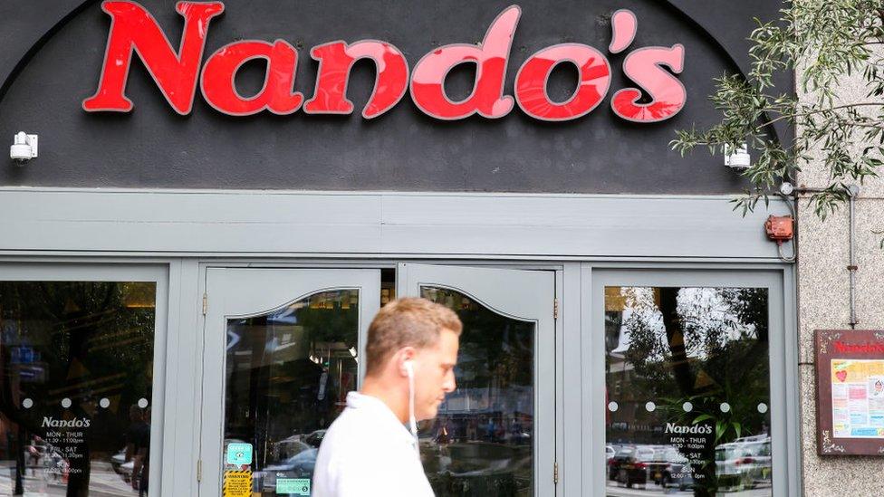 Man walks past Nando's