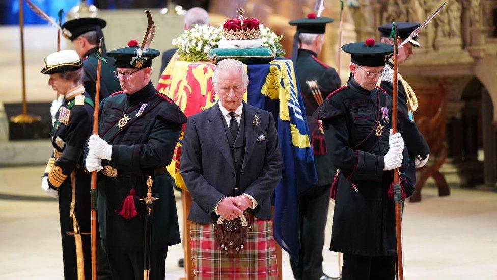 King Charles III standing by The Queen's coffin the vigil at St Giles Cathedral.