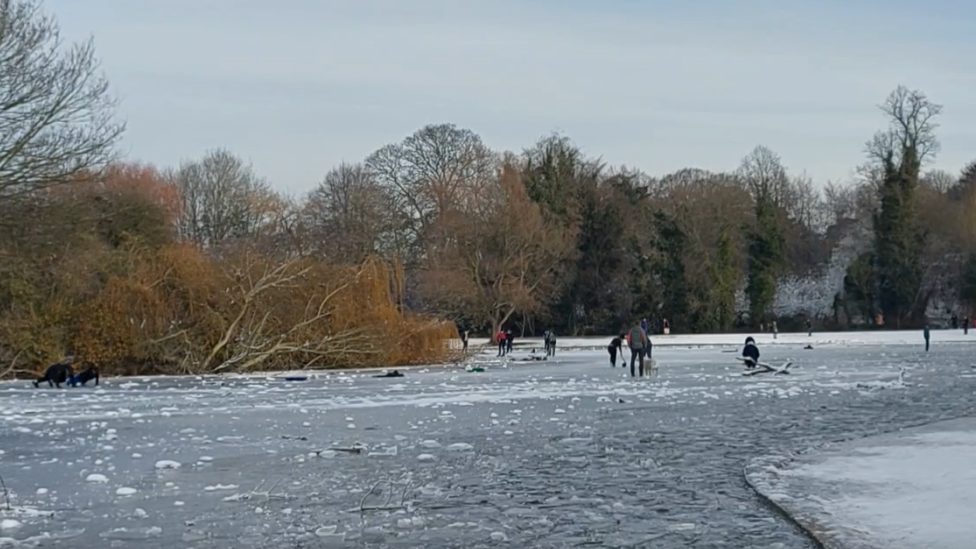 People playing on ice in Verulamium Park, St Albans