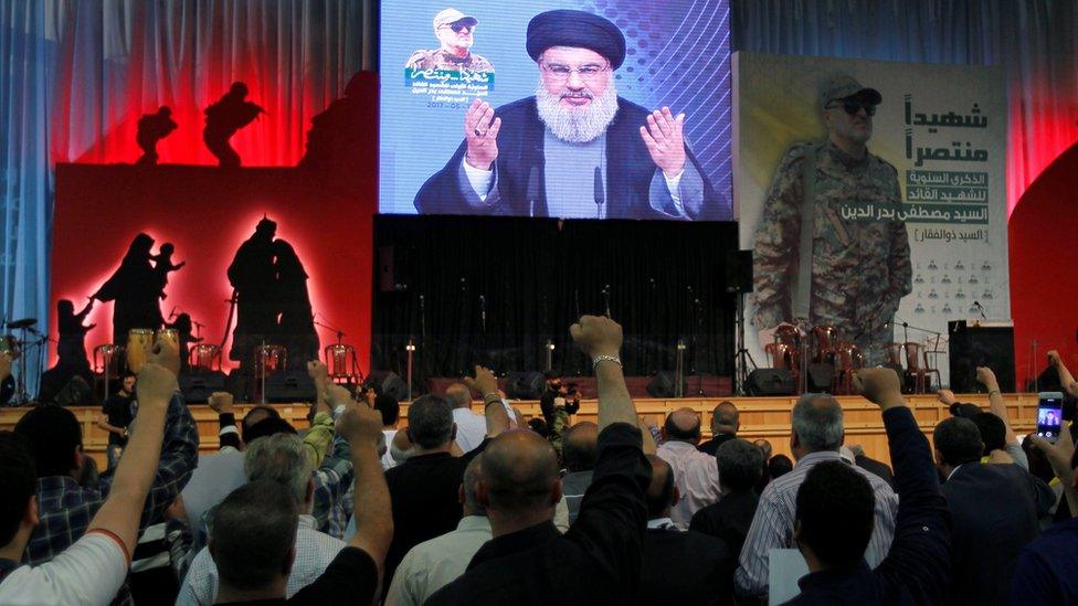 Hezbollah leader Hassan Nasrallah addresses supporters from a screen on 11 May 2017