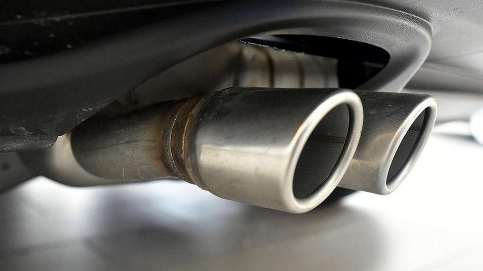 Exhaust pipes are seen on a Volkswagen vehicle at an auto dealership in San Francisco, California