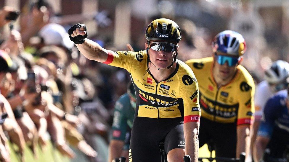 Dutch rider Olav Kooij (C) celebrates as he crosses the line to win at the finish of the opening stage of the Tour of Britain cycle race