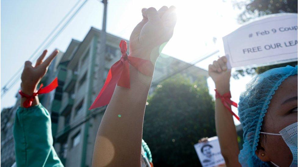 Medics holding banners and wearing red ribbons for demonstrating civil disobedience movement