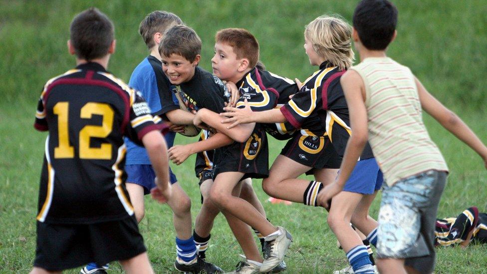 Boys play football in Sydney, Australia