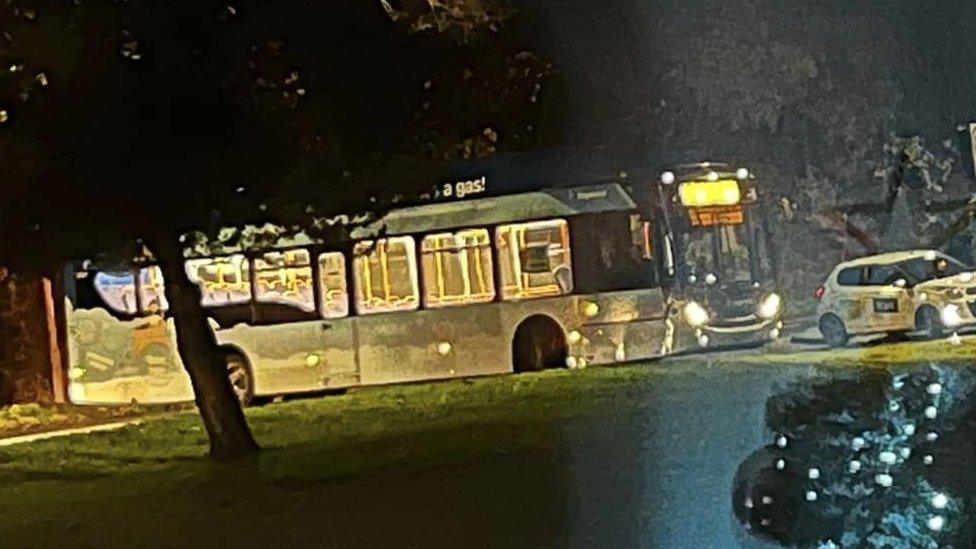 A bus stops after the road is disrupted