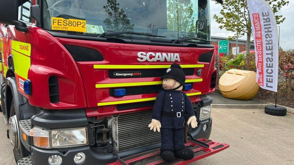 Knitted fireman on fire engine