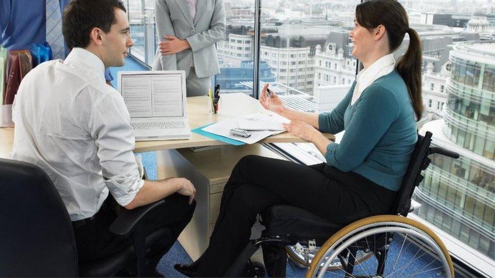 Office meeting with woman sitting in a wheelchair