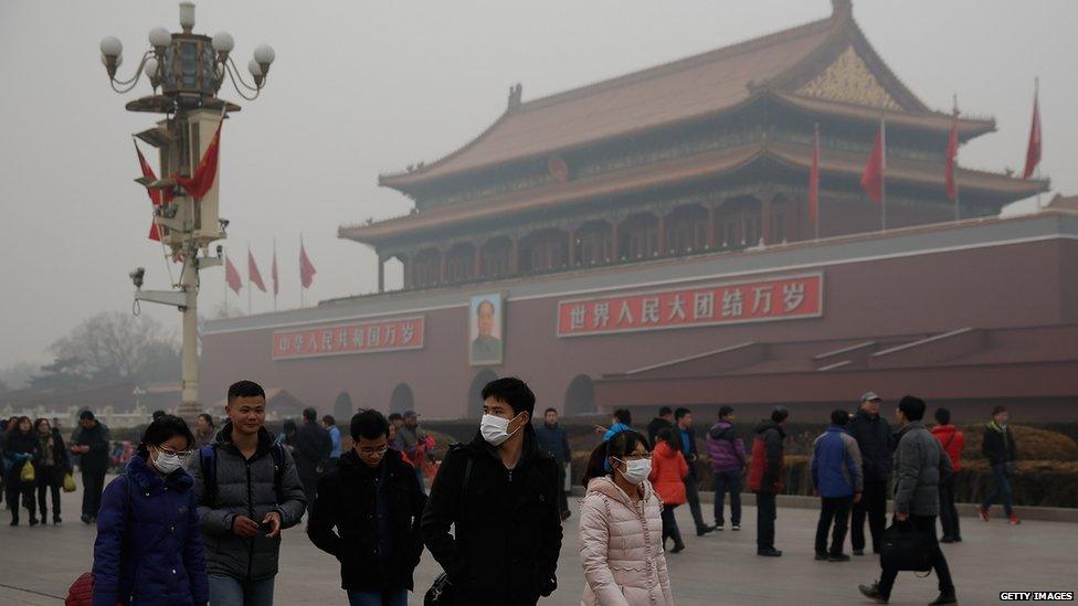 Chinese tourist wear the masks at the Tiananmen Square during severe pollution on February 25, 2014 in Beijing, China.