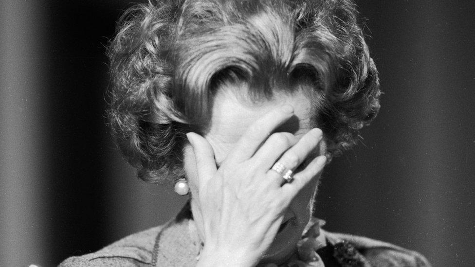 Margaret Thatcher with her head in her hands