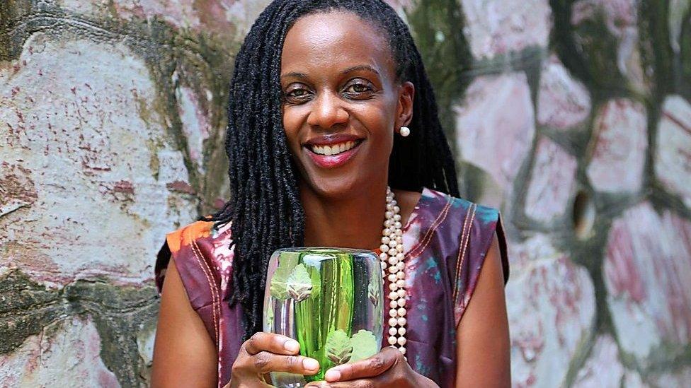 Catherine Nakalembe holding award