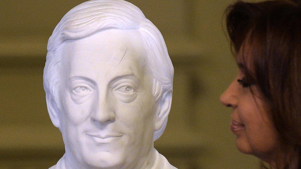 Argentine President Cristina Fernandez de Kirchner looks at a bust of late Argentine Presidnet (2002-2007) Nestor Kirchner after unveiling it during a farewell rally on her last day in power at Government Palace in Buenos Aires on December 9, 2015.