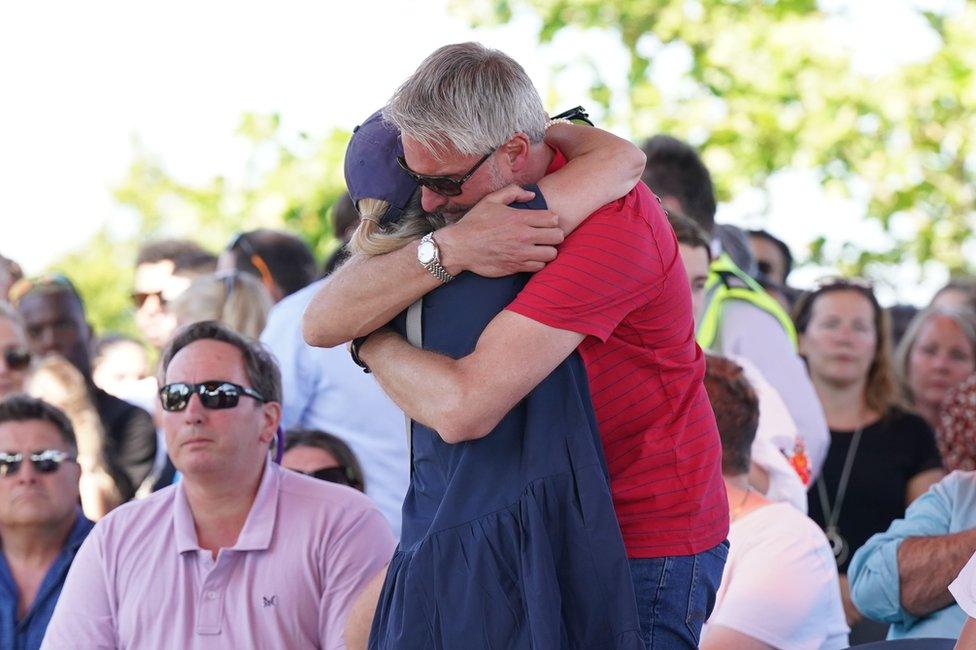 Barnaby Webber's father David embraces Grace O'Malley Kumar's mother ahead of a vigil at the University of Nottingham