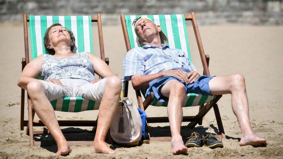 People in deckchairs, Barry, south Wales