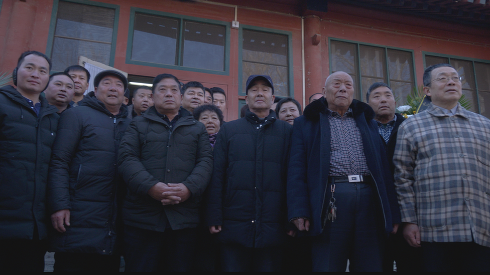 Visitors taking a group photo in front of the study of Zhao Ziyang