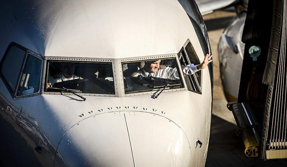 A pilot waves as a Ryanair plane arrives at Schipol Airport in Amsterdam, The Netherlands, on October 27, 2015