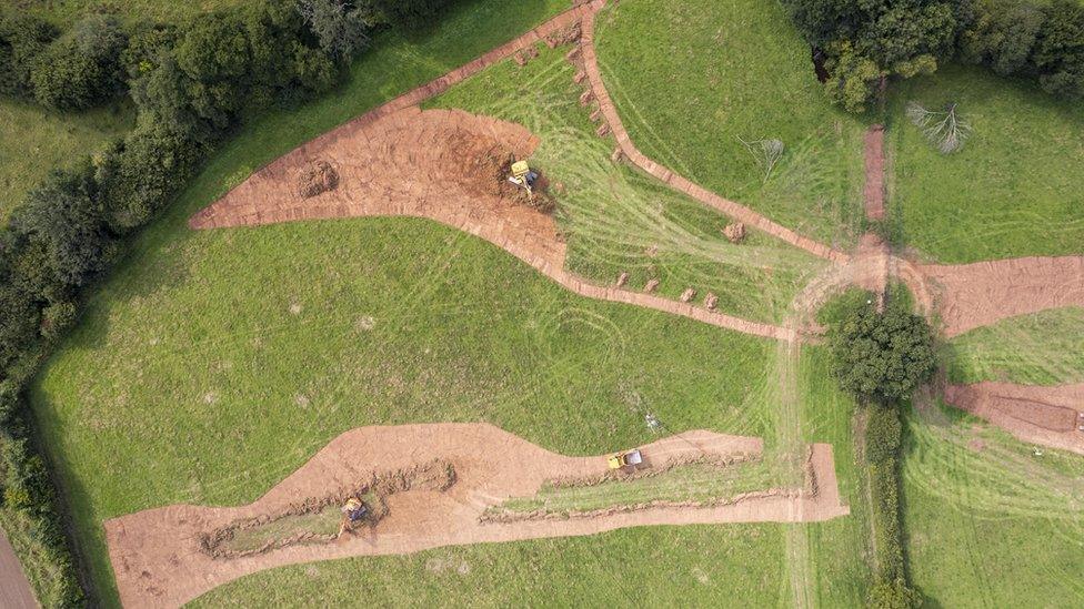 A green patch of grass with some work going on