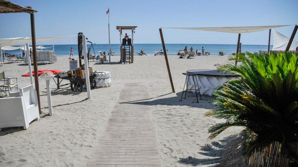 People enjoy a warm and sunny day at Punta Canna beach in Chioggia, near Venice, northern Italy, 10 July 2017