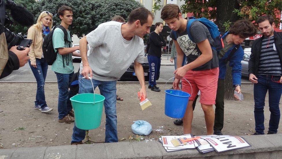 Gergely Kovacs and fellow activists putting up posters