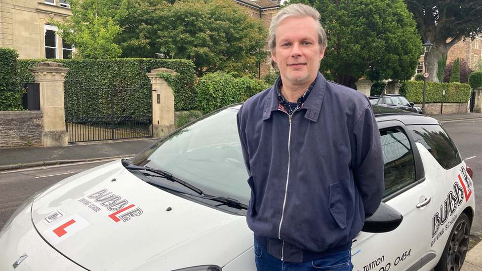 Marcus Sheppard standing in front of a learner driver car