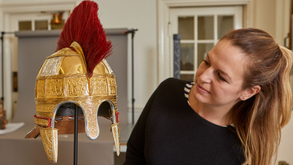 Lizzie Miller with one of the reconstructed helmets