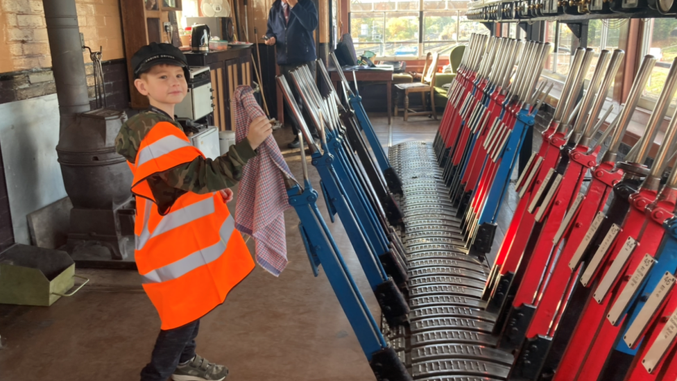 Corey playing with levers in a signal box