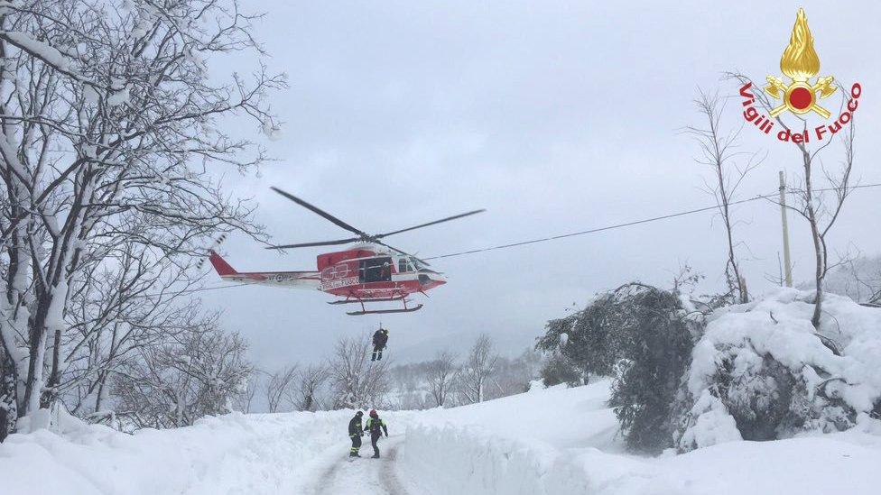 Rescuers arrive by helicopter