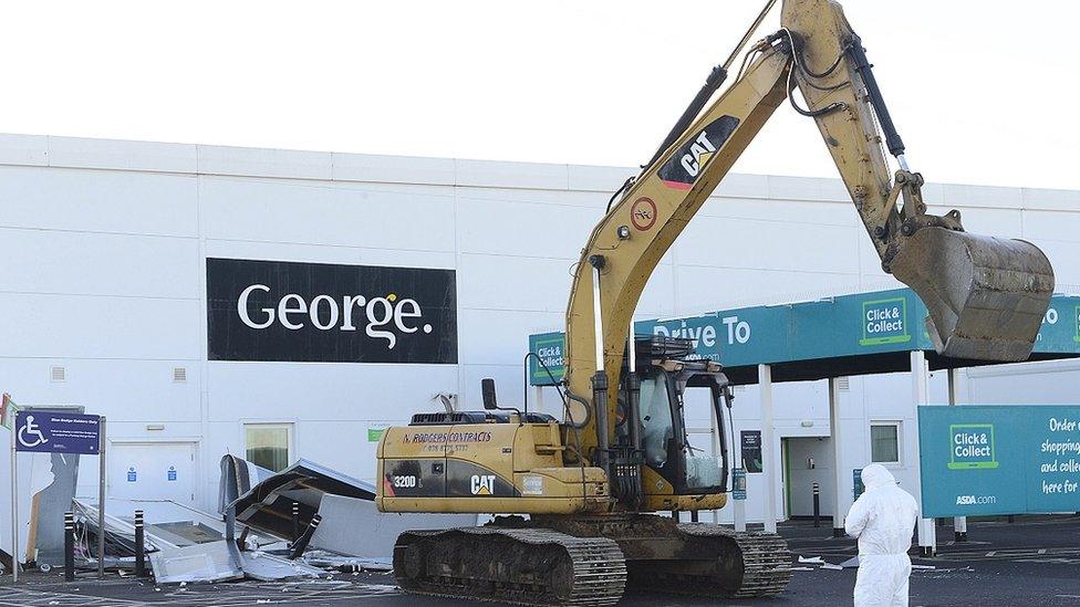 A large digger in the carpark of Asda in Antrim