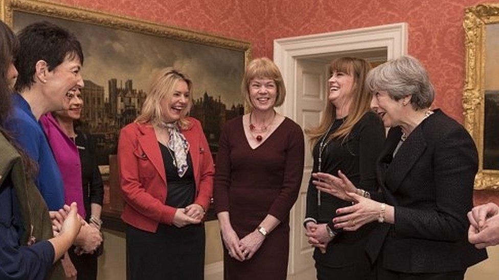 Theresa May with a number of female MPs appointed as whips