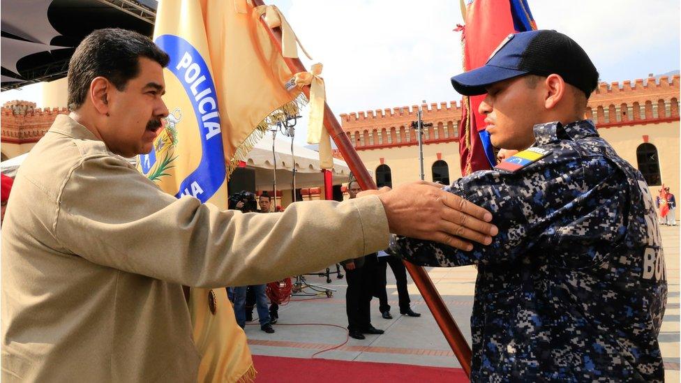 This handout picture released by Miraflores palace press office shows Venezuela's President Nicolas Maduro (L) during a military ceremony to commemorate the sixth anniversary of the death of President Hugo Chavez