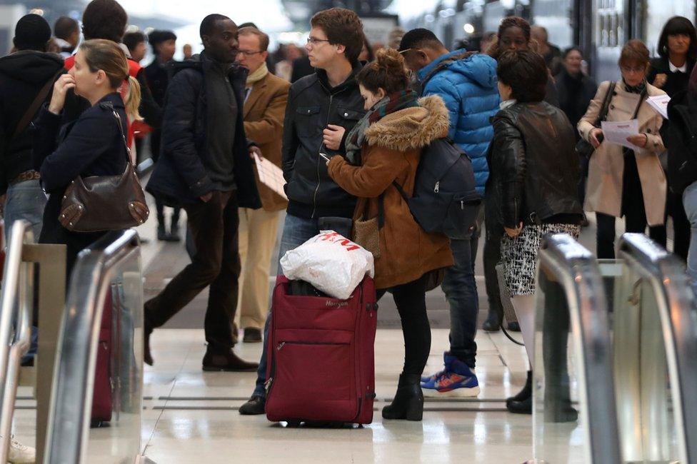 Passengers walk on a platform at the Gare de Lyon railway station on 1 June in Paris,