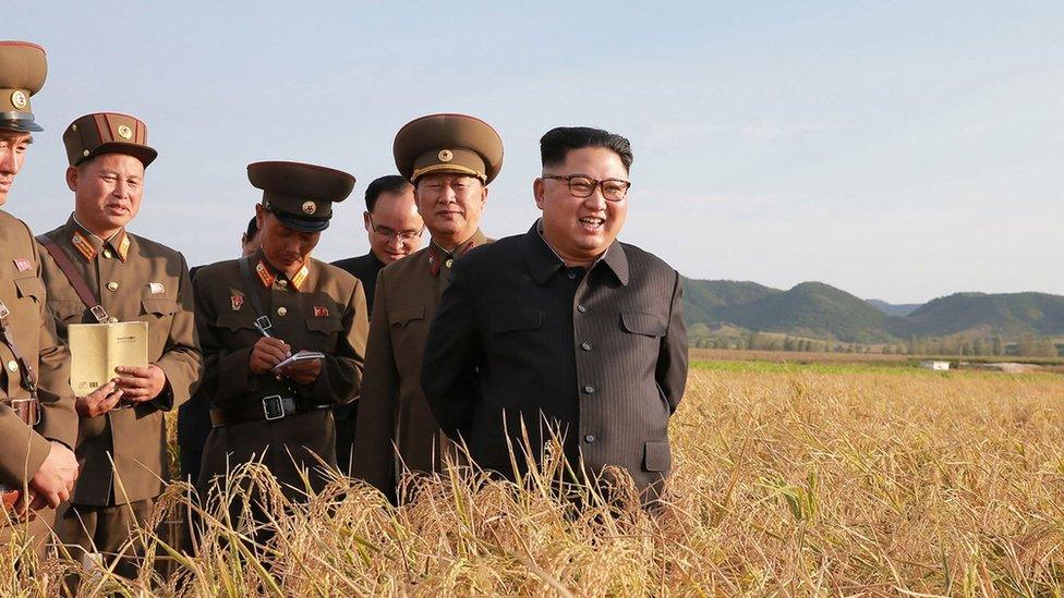 North Korean leader Kim Jong-Un (R) visiting Farm No. 1116