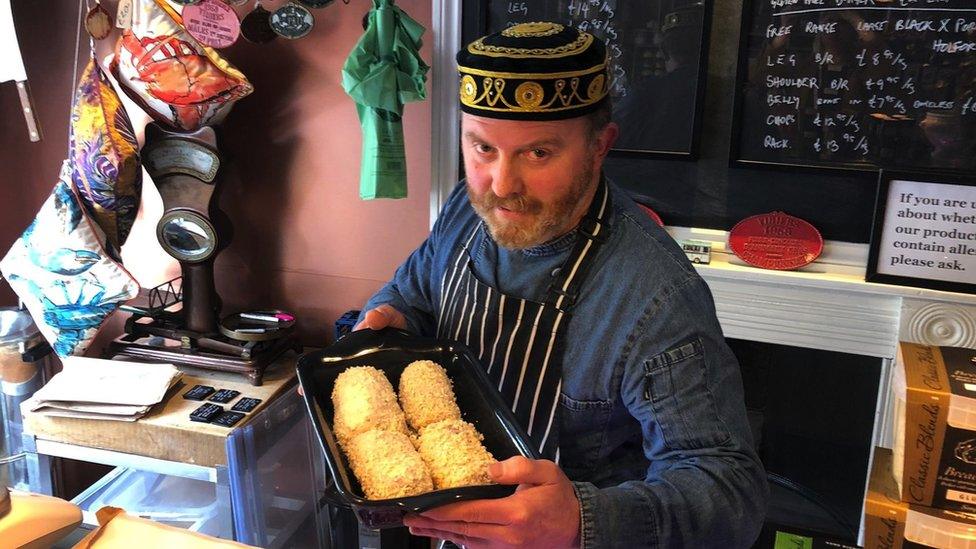 Andrew Moore holding chicken Kievs in a pan