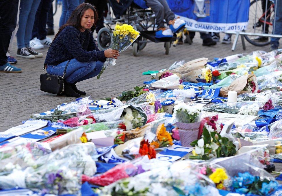 Leicester City football fans pay their respects outside the football stadium, after the helicopter of the club owner Thai businessman Vichai Srivaddhanaprabha crashed when leaving the ground on Saturday evening after the match, in Leicester, Britain, October 28, 2018