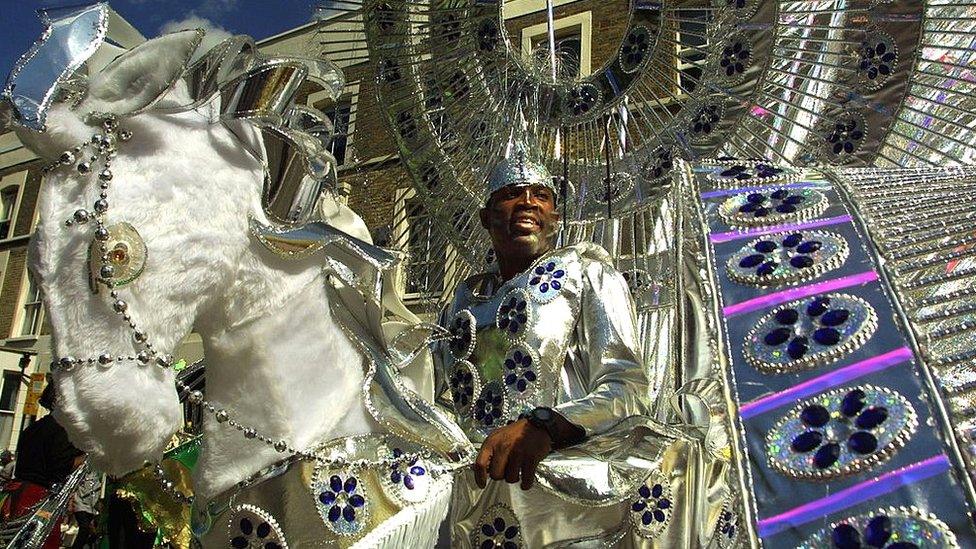 A man from a ''Mas'' (masquerade) band dances in the street in 2001