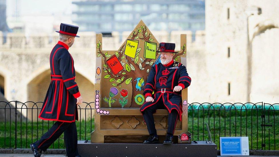 Yeoman of the guard make use of the coronation benches designed by schoolchildren across the UK which will be at the Tower of London throughout the summer