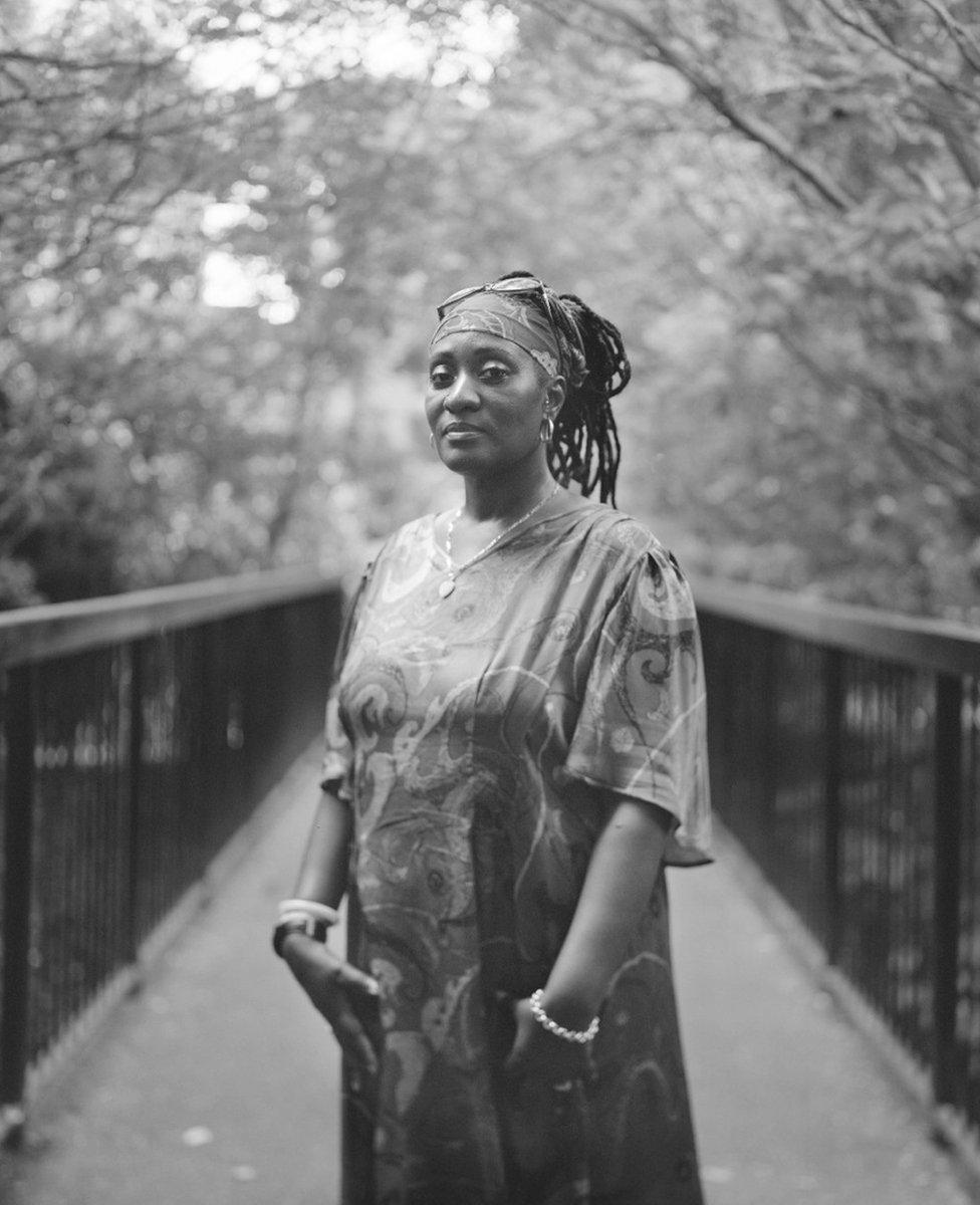 A woman poses for a portrait