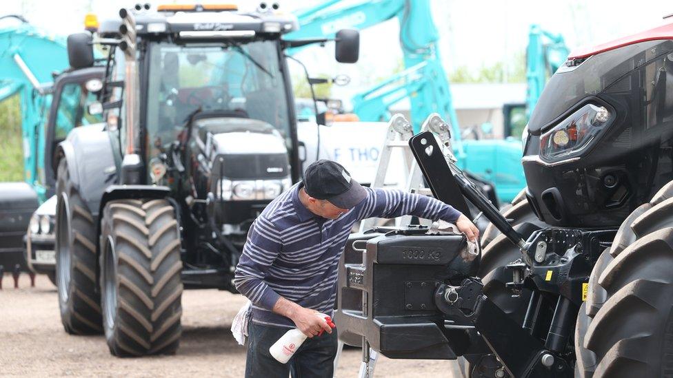 A man polishes a tractor at Balmoral Show