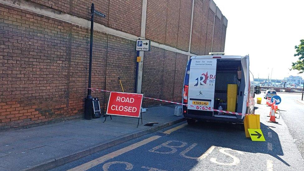 A section of the road and footpath closed off