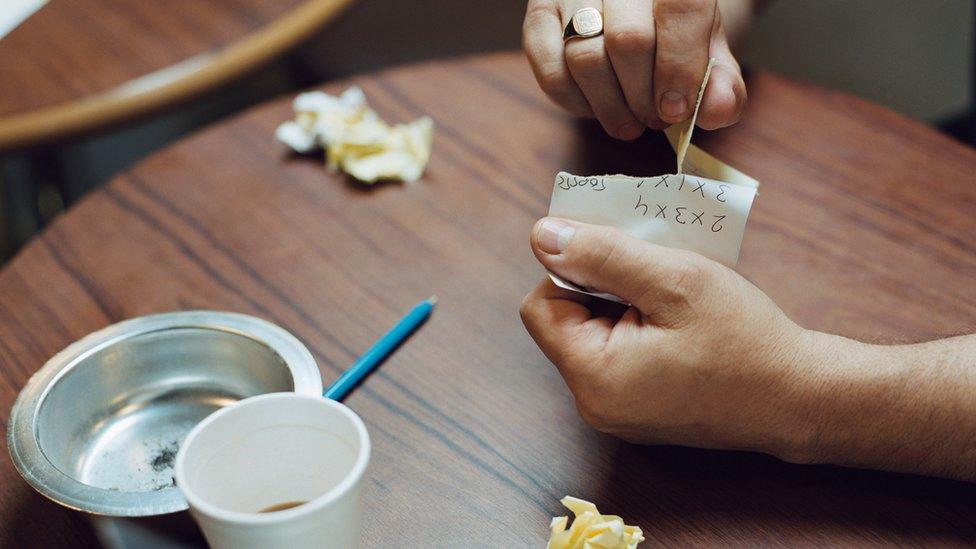 Picture of man's hands in a bookies