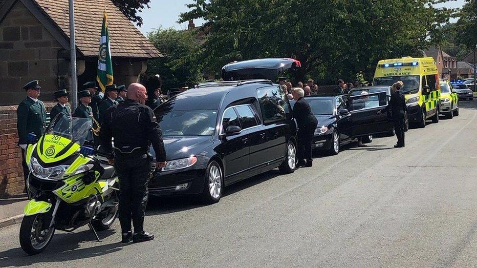 Funeral cars arriving outside of the church