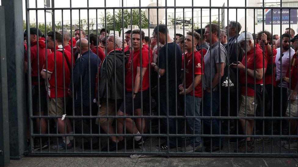 Fans waiting outside the gates to enter the stadium as kick off is delayed before the UEFA Champions League Final at the Stade de France